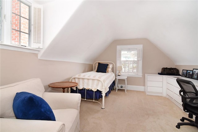 bedroom featuring light colored carpet and vaulted ceiling