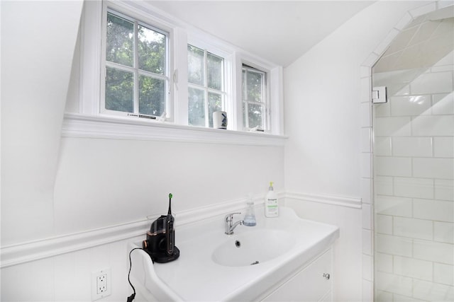 bathroom with vanity and lofted ceiling