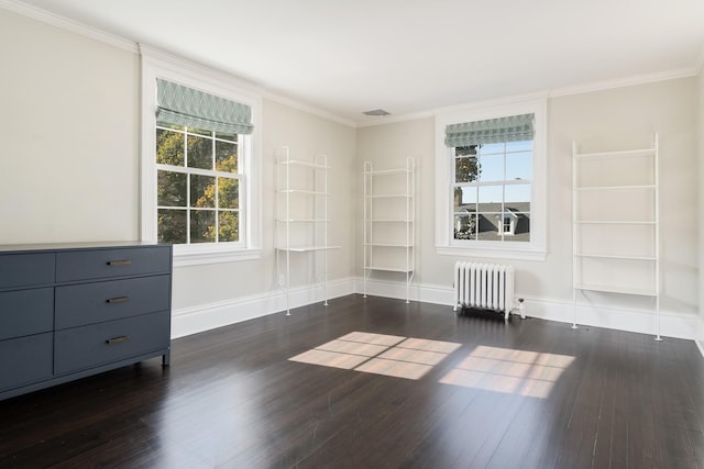 empty room featuring radiator heating unit, dark hardwood / wood-style floors, and ornamental molding