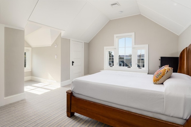 bedroom with carpet floors and vaulted ceiling