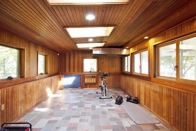 workout area featuring plenty of natural light, wooden walls, and wood ceiling