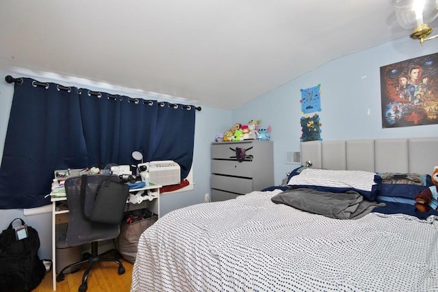 bedroom with wood-type flooring and vaulted ceiling