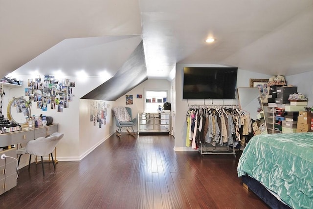 bedroom with dark wood-type flooring and lofted ceiling