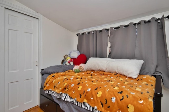 bedroom with a closet and lofted ceiling