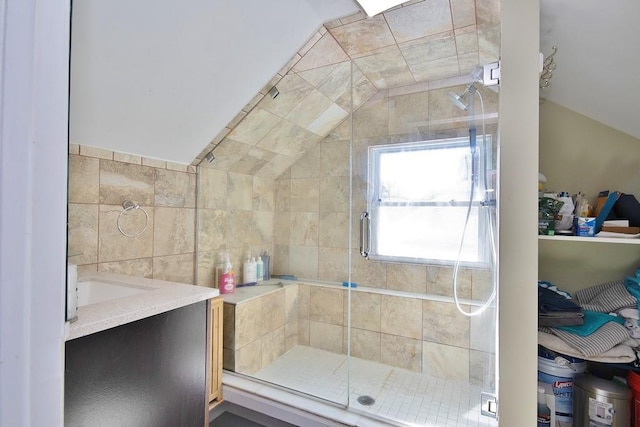 bathroom featuring a shower with door, vanity, and lofted ceiling