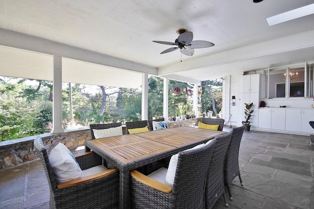 sunroom / solarium featuring a skylight and ceiling fan