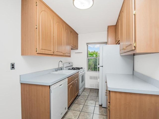 kitchen with radiator, white appliances, sink, light tile patterned floors, and light brown cabinets