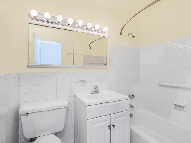 full bathroom with vanity, shower / bath combination, and tile walls