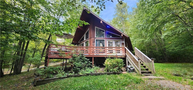 back of property featuring a wooden deck