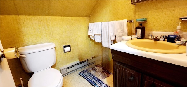 bathroom with vanity, a baseboard radiator, vaulted ceiling, and toilet