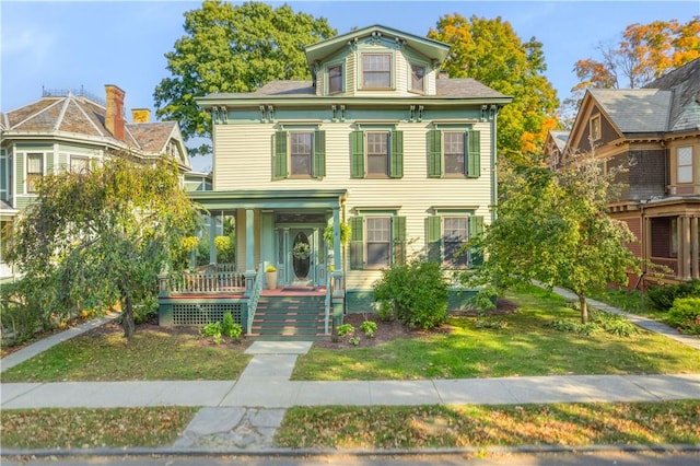 italianate-style house with covered porch and a front yard