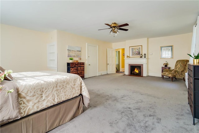 bedroom with ceiling fan and light carpet