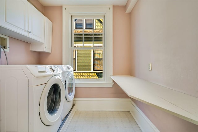 washroom featuring cabinets and independent washer and dryer