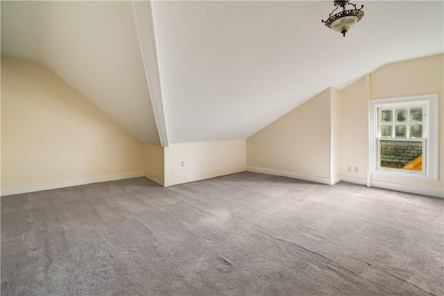 bonus room featuring carpet flooring and vaulted ceiling