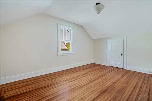 bonus room with wood-type flooring and lofted ceiling