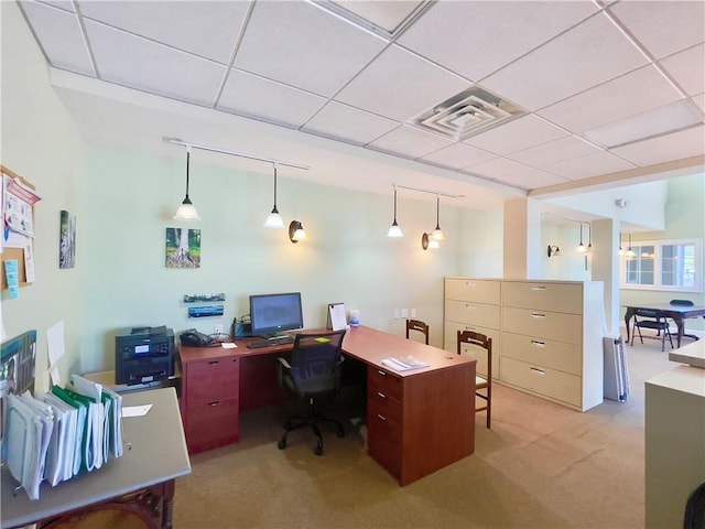 carpeted office with a paneled ceiling