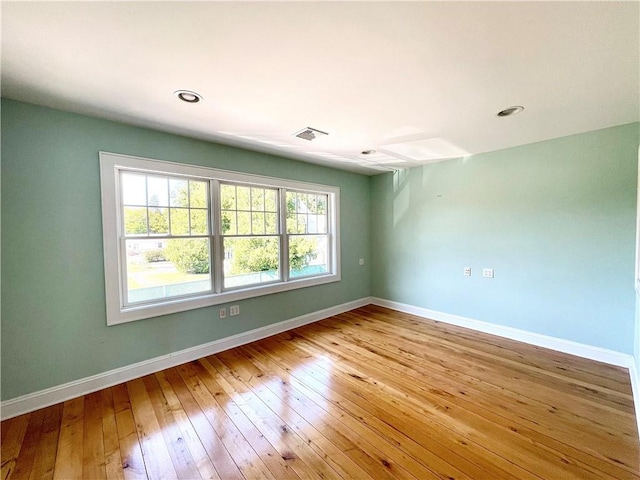 spare room featuring light hardwood / wood-style floors