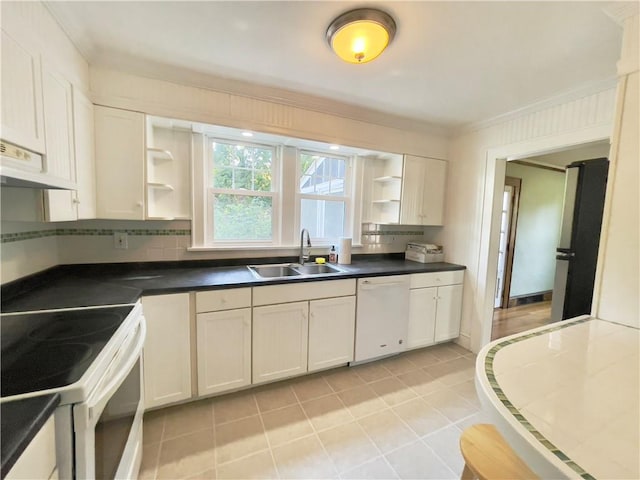 kitchen featuring sink, white cabinets, light tile patterned flooring, and white appliances