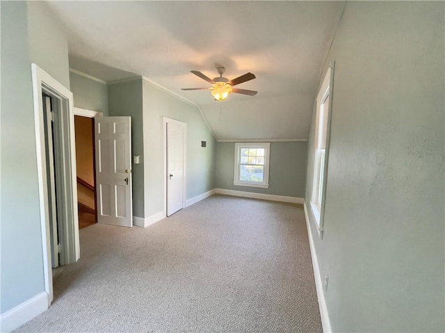 additional living space featuring light colored carpet, vaulted ceiling, and ceiling fan