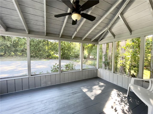 unfurnished sunroom featuring lofted ceiling with beams, ceiling fan, and wood ceiling