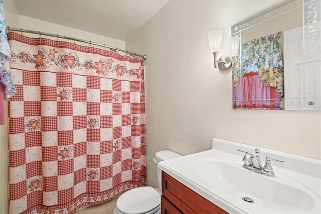 bathroom with tile patterned floors, vanity, toilet, and walk in shower