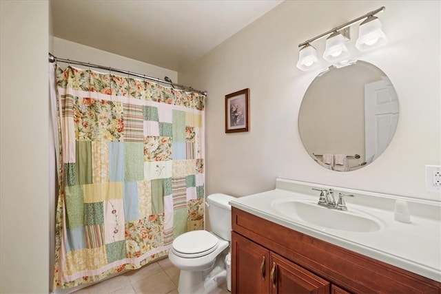 bathroom with tile patterned flooring, vanity, and toilet