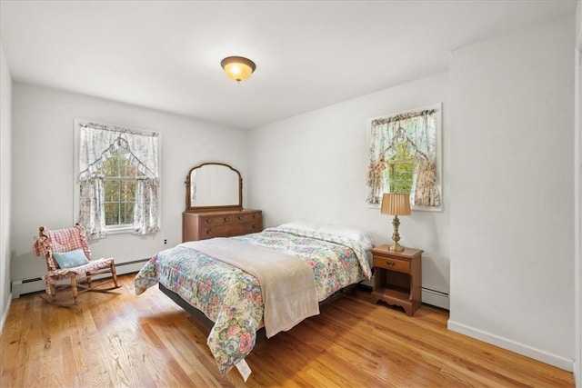 bedroom featuring light hardwood / wood-style flooring and baseboard heating