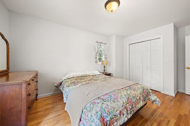 bedroom with light wood-type flooring and a closet