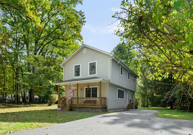 view of front of home featuring a porch and a front lawn