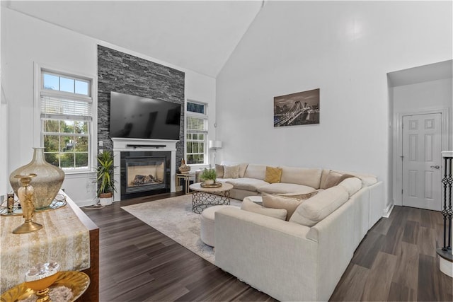 living room featuring a fireplace, high vaulted ceiling, and dark hardwood / wood-style floors