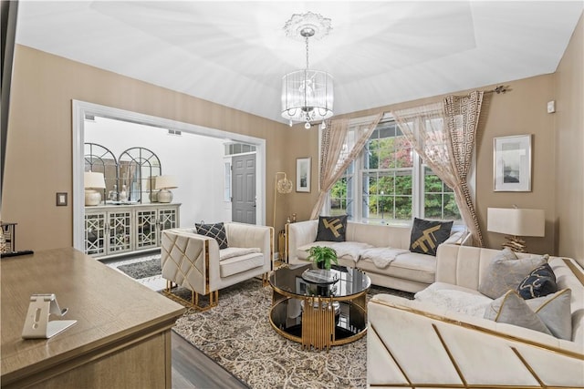 living room with hardwood / wood-style flooring and a notable chandelier