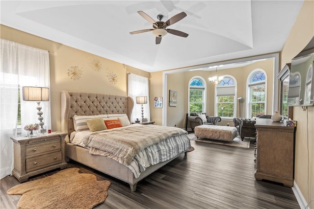 bedroom with dark hardwood / wood-style flooring, ceiling fan with notable chandelier, and lofted ceiling