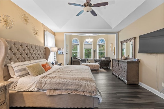 bedroom with ceiling fan with notable chandelier, dark wood-type flooring, and lofted ceiling