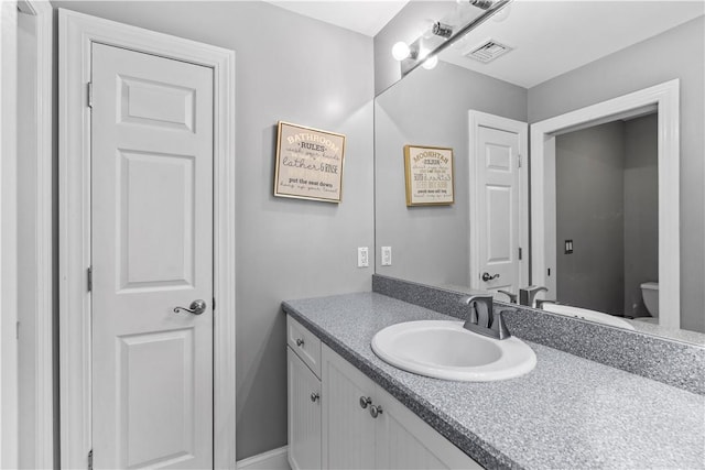 bathroom with vanity and toilet