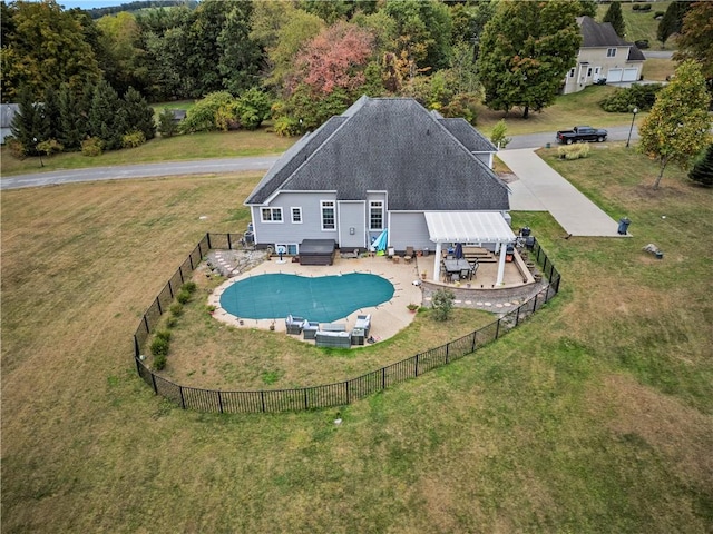 view of pool with a hot tub and a lawn