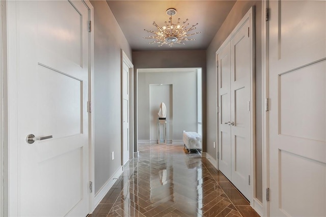 hallway featuring a notable chandelier