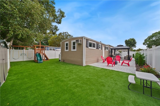 view of yard featuring a gazebo, an outdoor structure, a patio area, and a playground