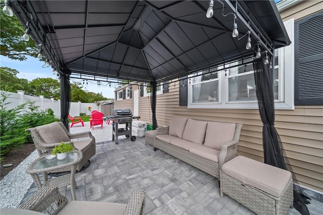 view of patio with outdoor lounge area, a gazebo, and a grill