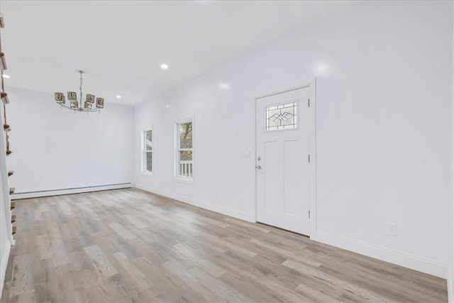 entrance foyer with a chandelier, light hardwood / wood-style floors, and baseboard heating