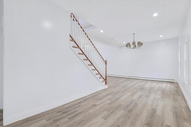 interior space featuring a chandelier, a baseboard radiator, and light hardwood / wood-style flooring