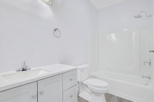 full bathroom featuring hardwood / wood-style floors, vanity, shower / bath combination, and toilet