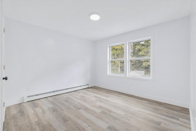 unfurnished room with light hardwood / wood-style floors and a baseboard radiator