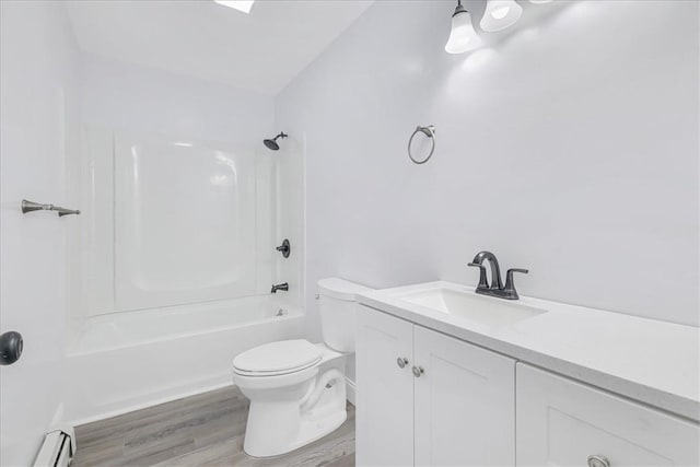 full bathroom with shower / bathing tub combination, vanity, a baseboard heating unit, toilet, and wood-type flooring