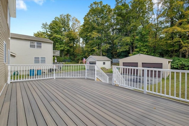 deck featuring an outbuilding and a garage