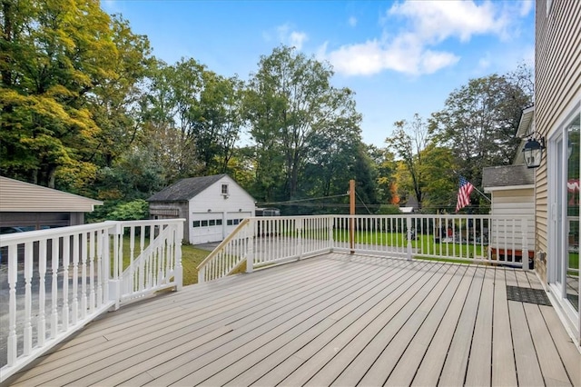 deck with a garage, an outbuilding, and a yard