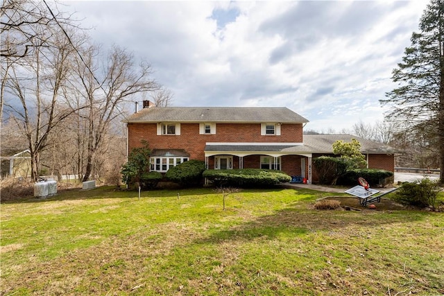 rear view of property with a lawn