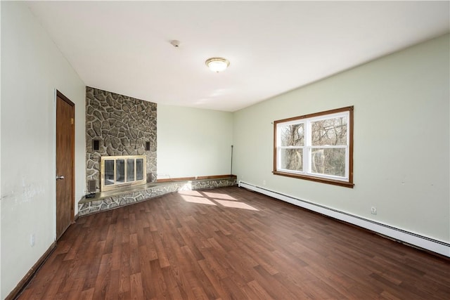 unfurnished living room featuring a stone fireplace, hardwood / wood-style flooring, and a baseboard heating unit