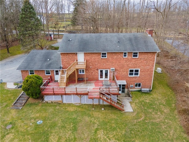 back of house featuring a yard and a wooden deck