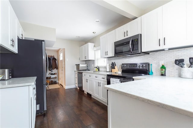 kitchen featuring dark hardwood / wood-style floors, white cabinetry, stainless steel appliances, and decorative light fixtures