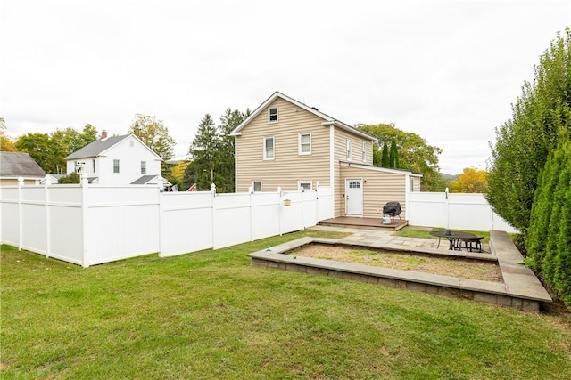 back of property with a yard and a patio area